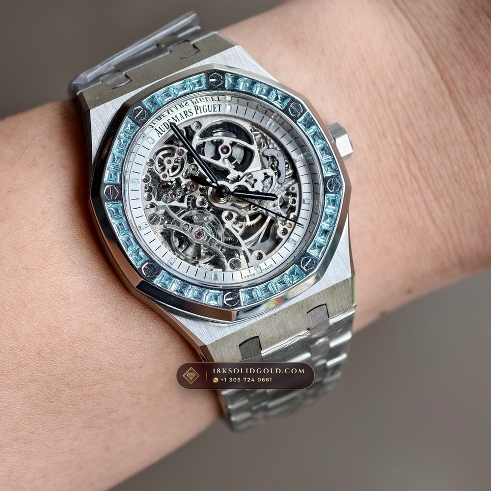 Audemars Piguet Royal Oak Double Balance Wheel Openworked 41mm Baguette Blue Topaz Bezel 18K White Gold Reference 15412BC.TO.1220BC.01 — Hallmarked Edition — Studio Angle 19 in 18K White Gold Au750 (224.8g Verified Mass, Audemars Piguet Cal. 3132 Dual-Balance Openworked)